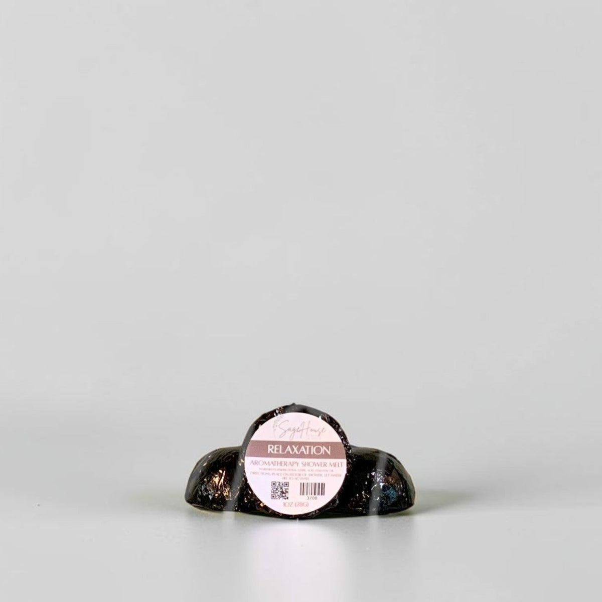 One labeled shower melt propped in front of 2 other shower melts. Sitting on a white background.