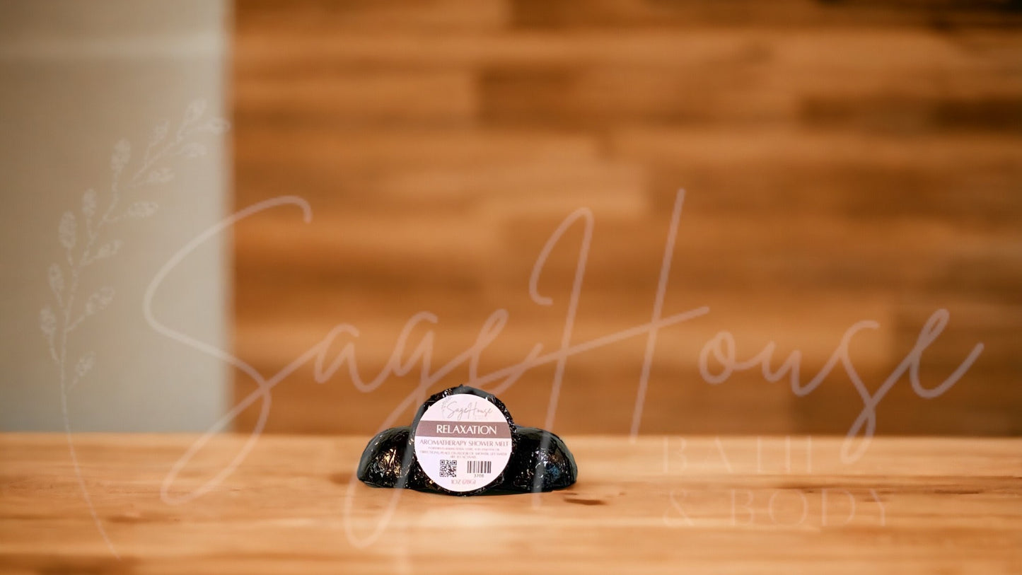 Aromatherapy shower melt in black packaging labeled "relaxation", on wood surface