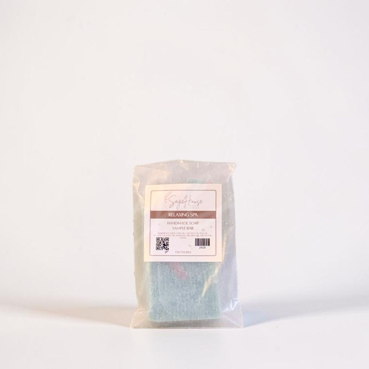 A sample bar of soap inside of a frosted glassine bag with label. Sitting on a white background.