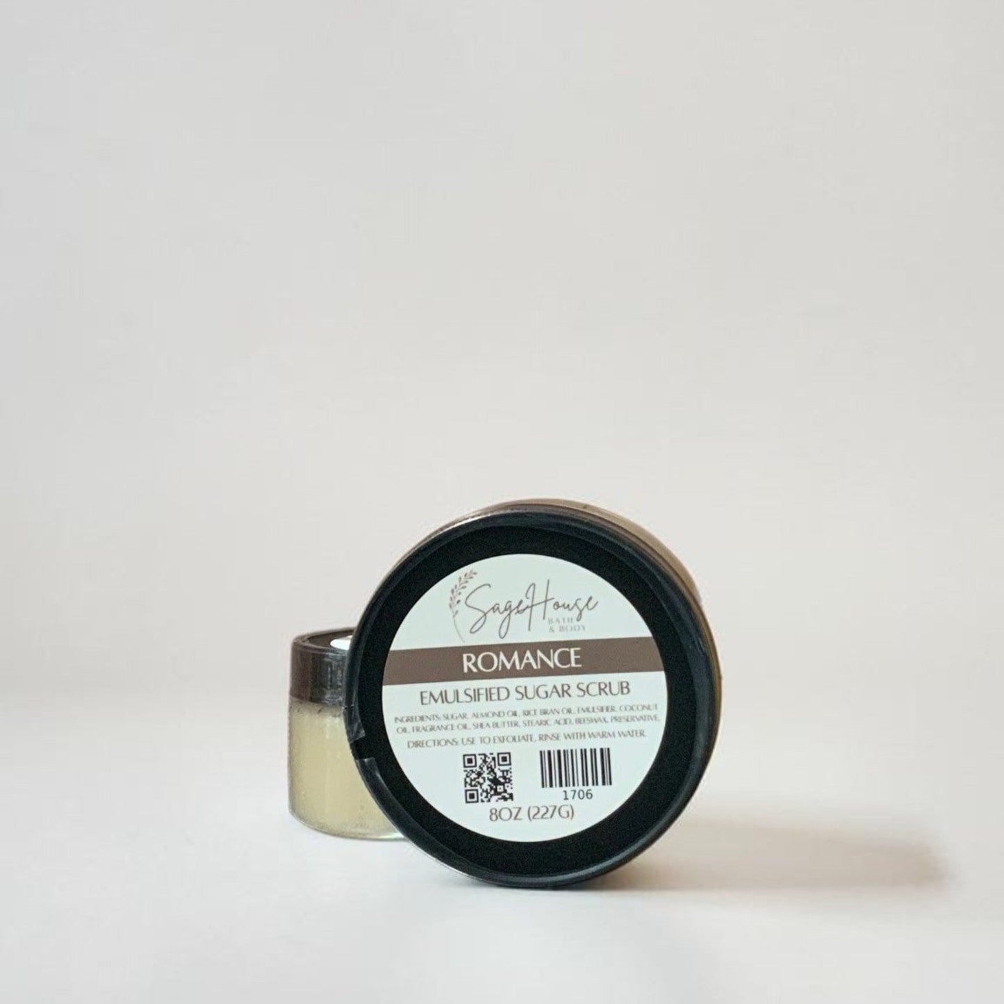 Two jars of Sugar scrub with label on a grey background.