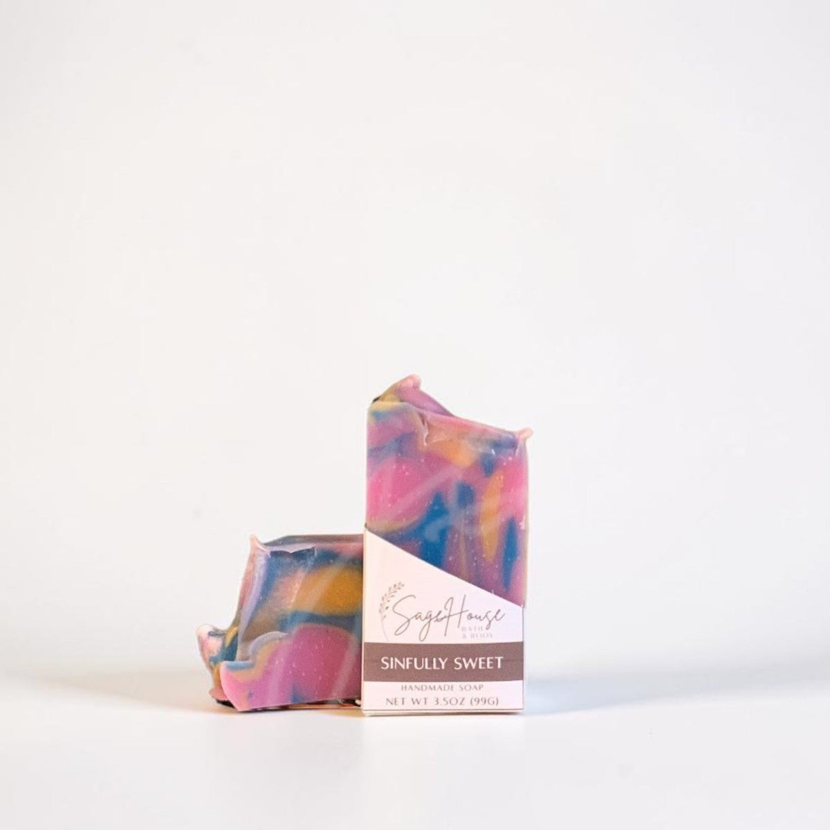 A labeled bar of soap sitting in front of a matching soap. On a white background.