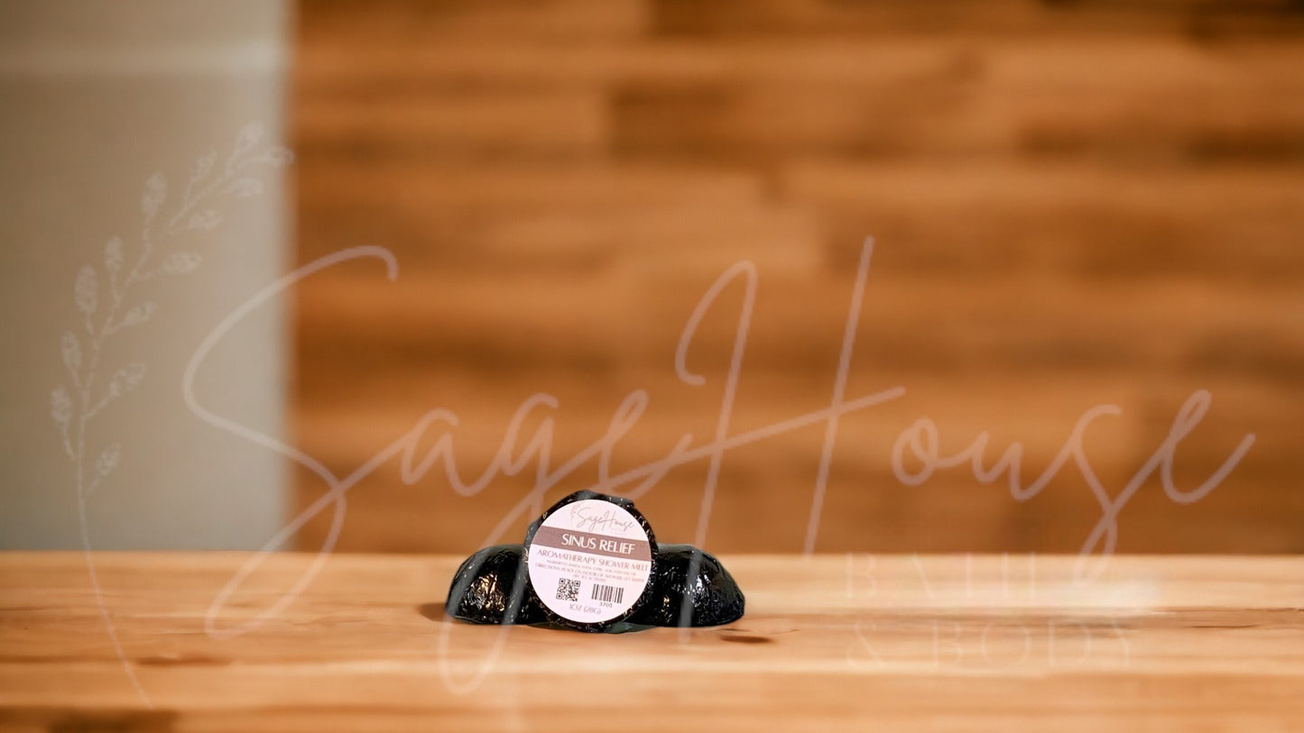 Aromatherapy shower melt in black packaging labeled "sinus relief" on wood surface