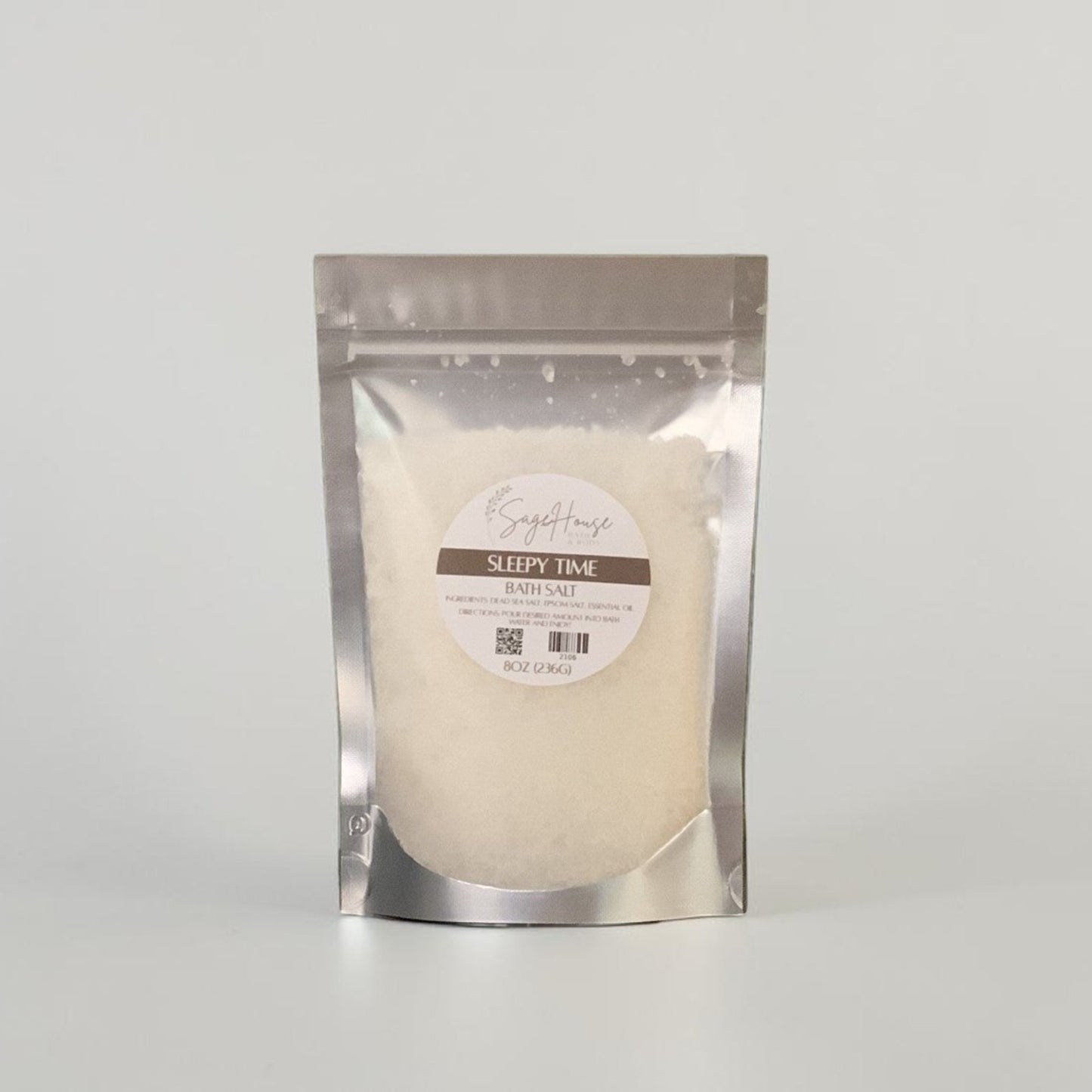 Silver package with a label, on a grey background.