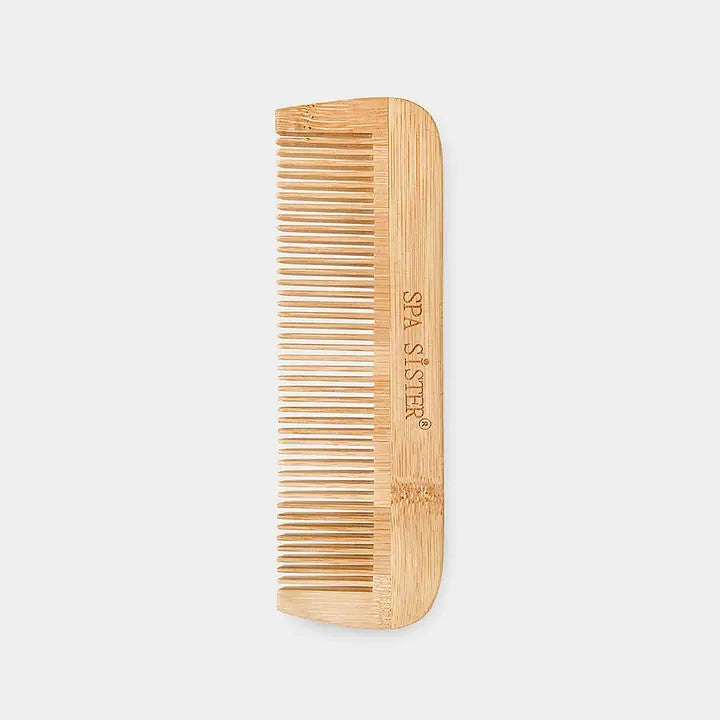 A bamboo detangling comb with fine teeth, laying on a white background.