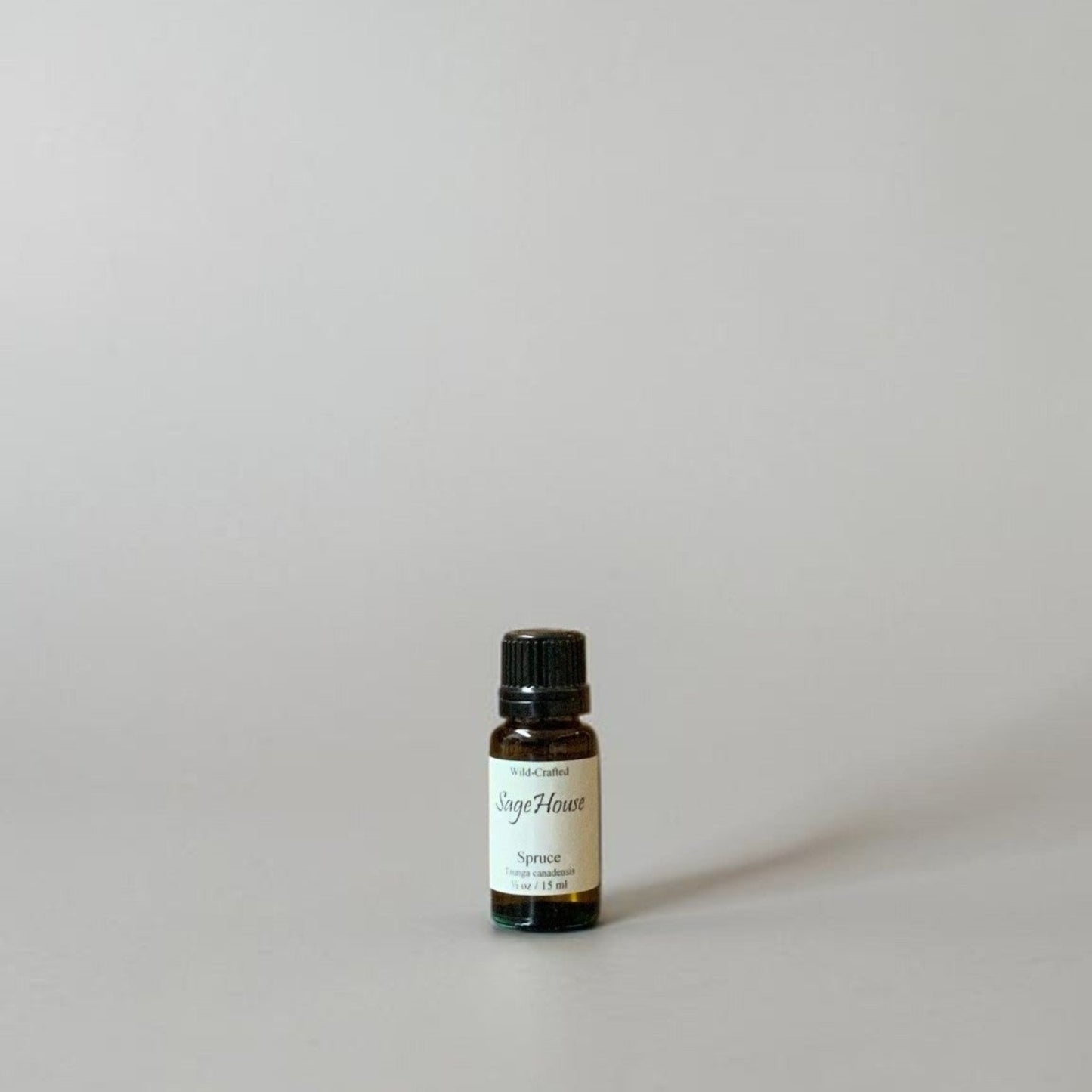 Bottle of Essential oil on a grey background.