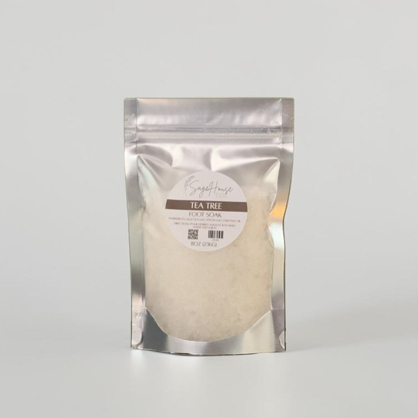 Silver packaging with a label, on a grey background.