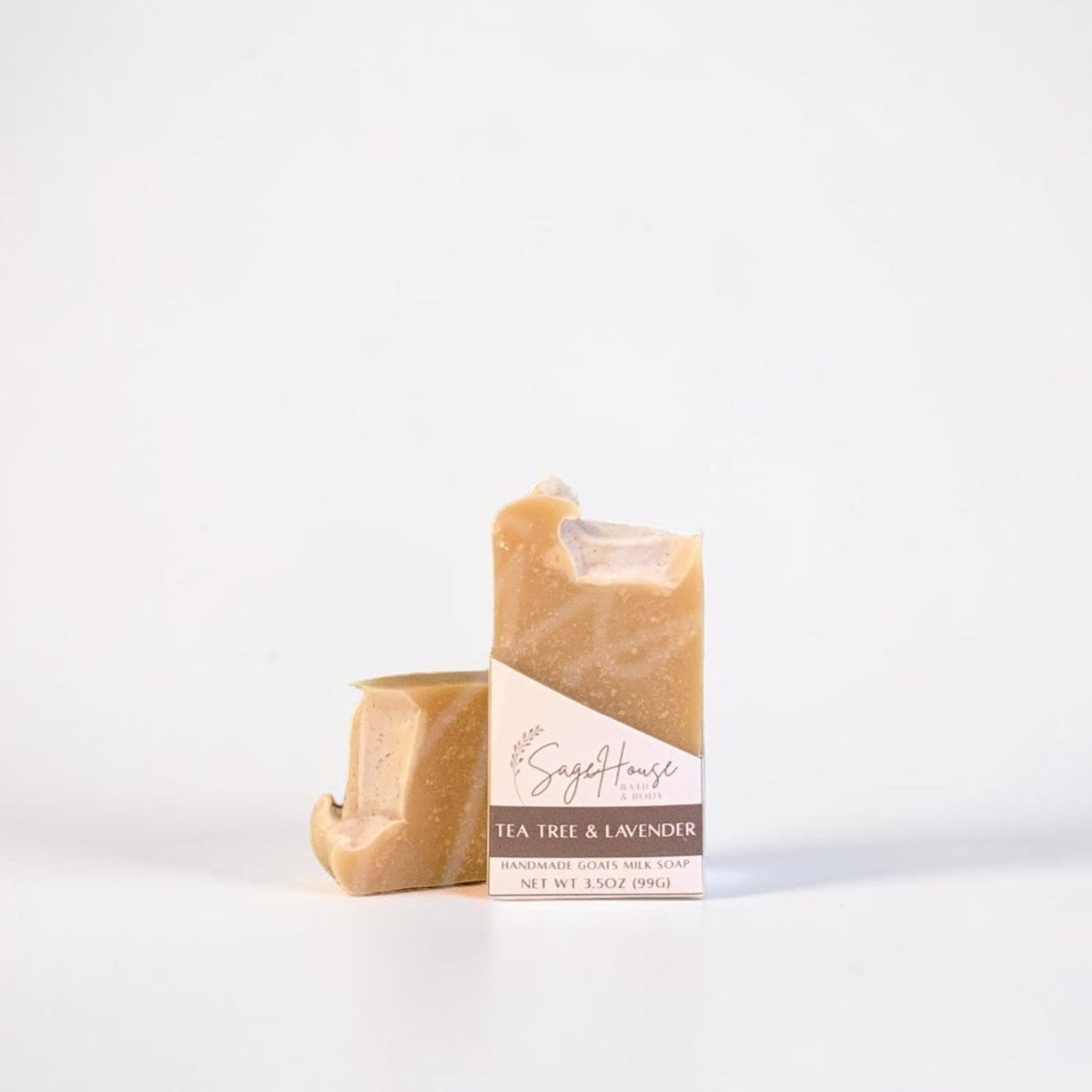 A labeled bar of soap sitting in front of a matching bar of soap. On a white background.