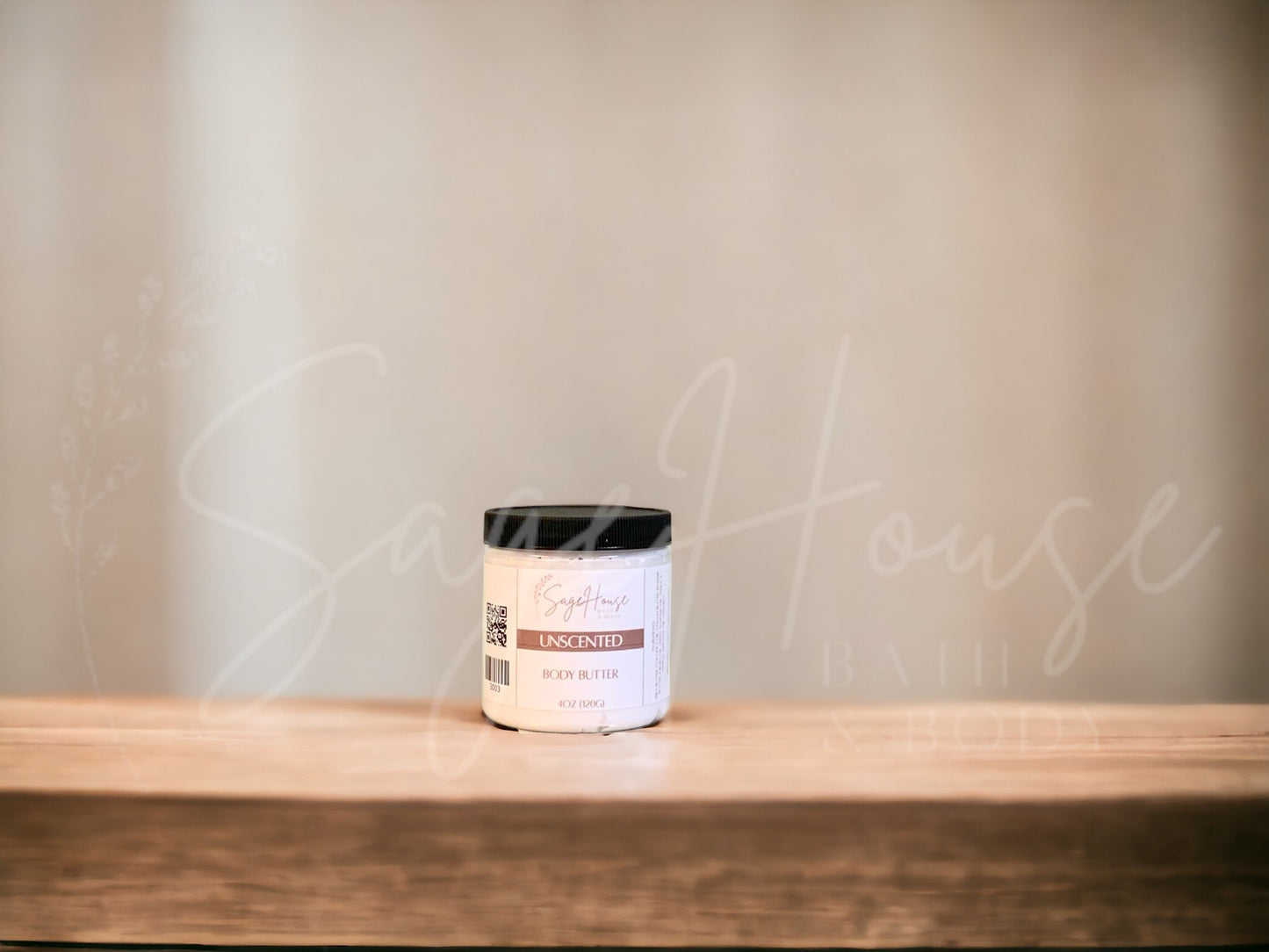 A jar of Unscented Body Butter placed on a wooden surface with a neutral background.