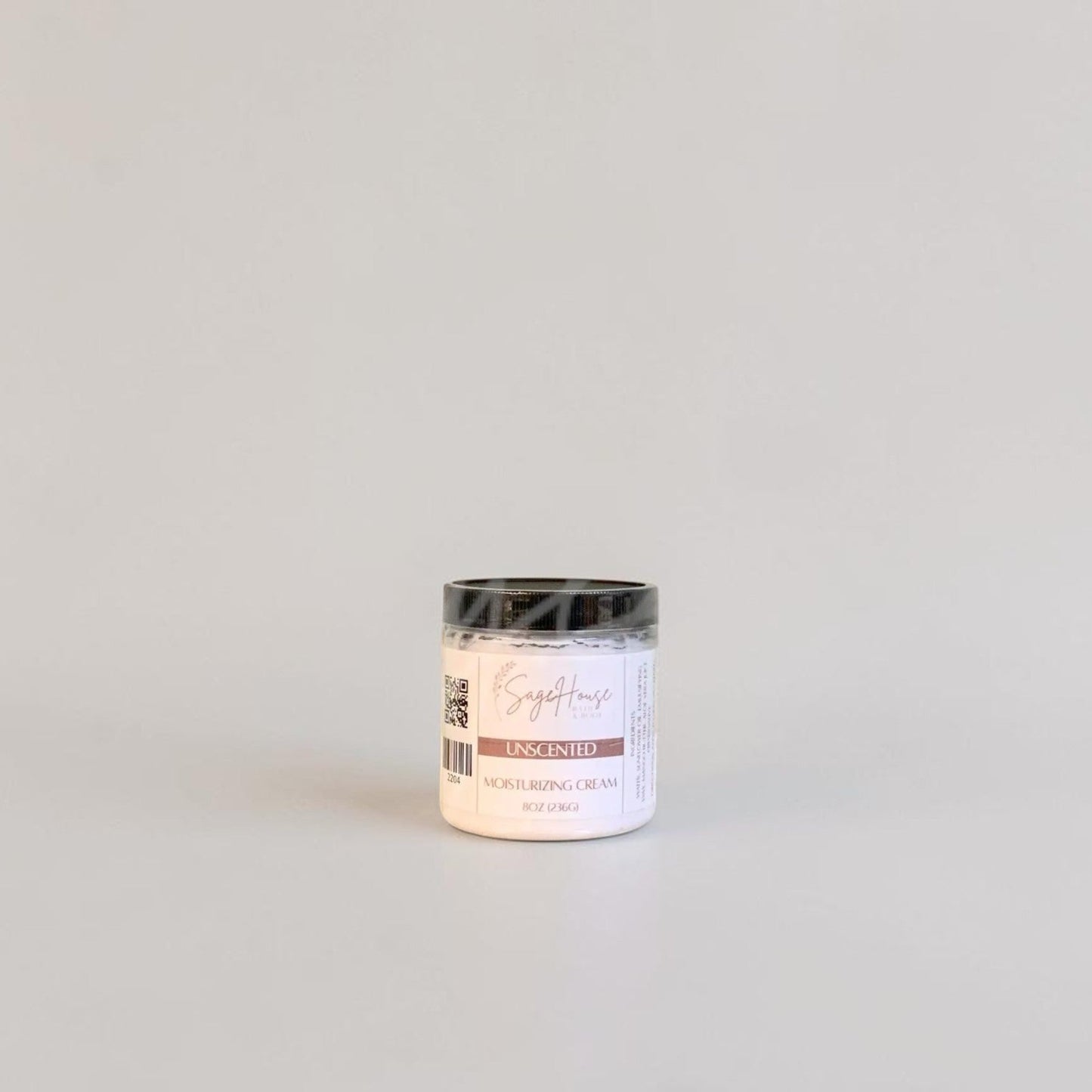 A labeled jar with a black lid. On a neutral background.