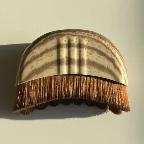 palm-sized lymphatic facial dry brush with soft vegan bristles for sculpted skin.