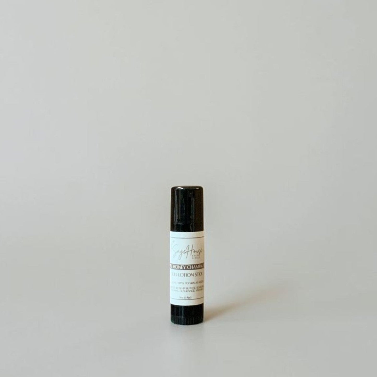 A black tube with label on a light gray background