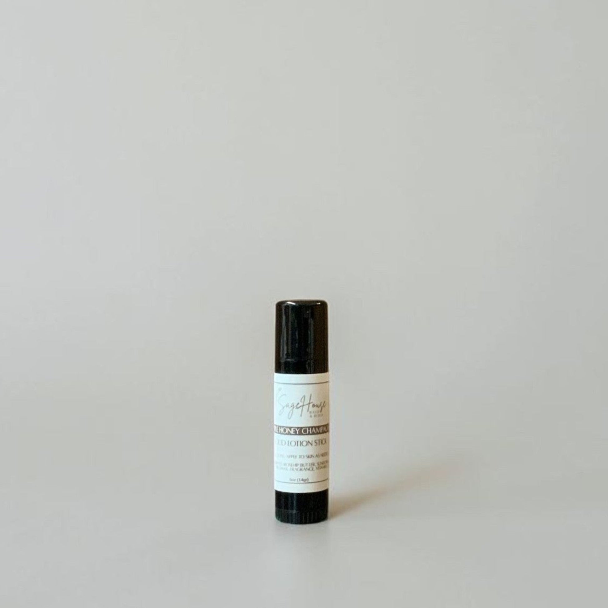 A black tube with label on a light gray background