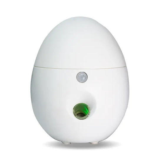 White egg-shaped device with a green mist port on a white background