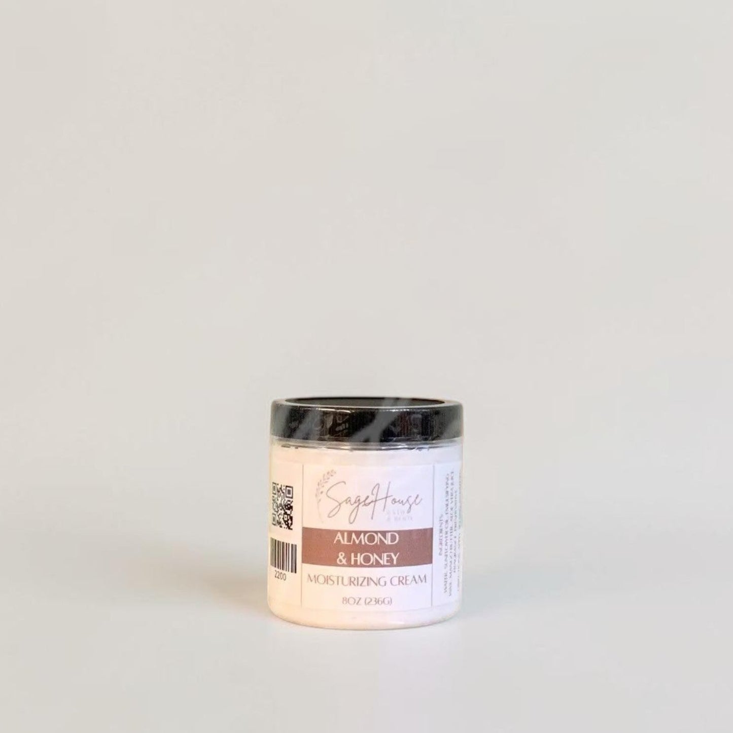 A labeled jar with a black lid. On a neutral background.