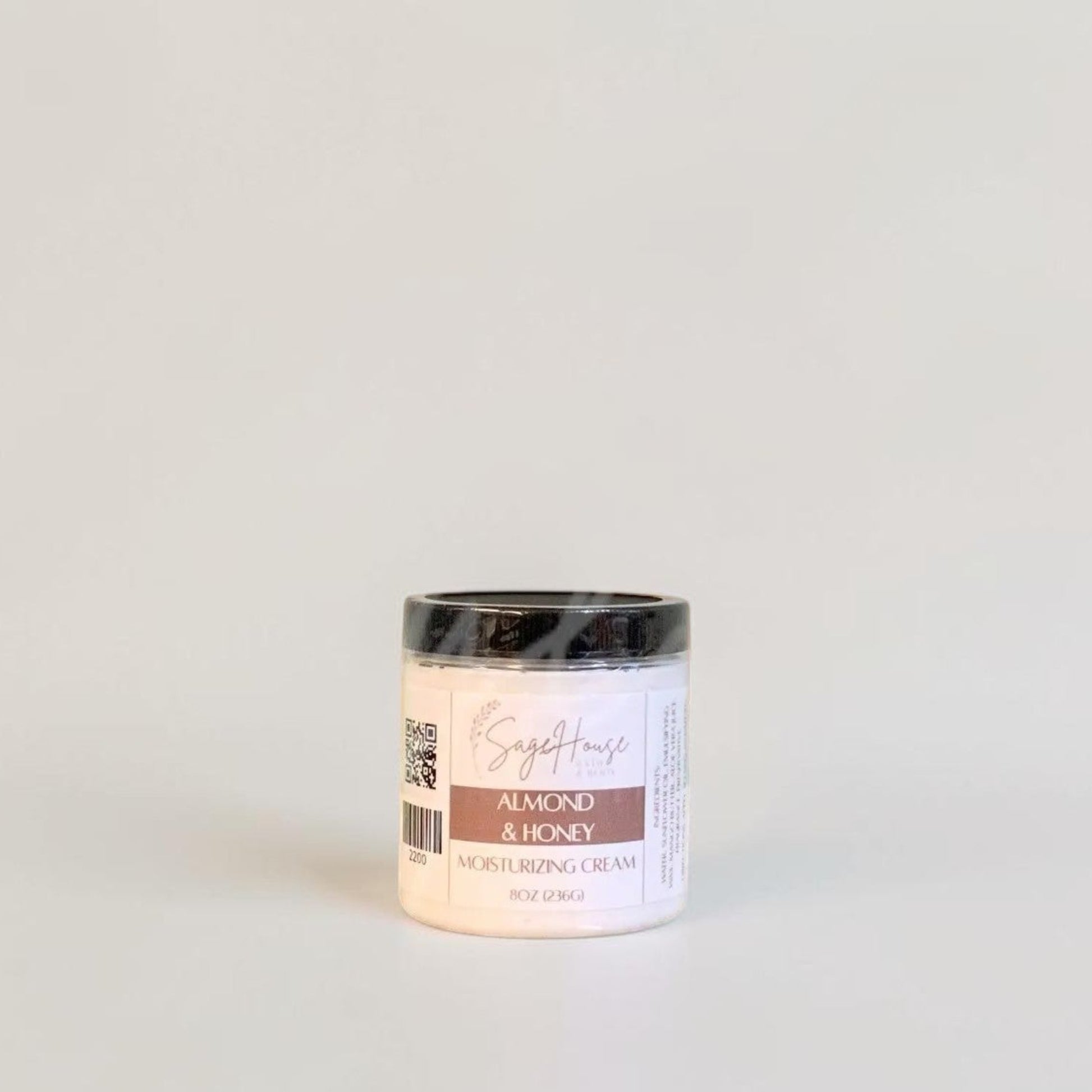 A labeled jar with a black lid. On a neutral background.