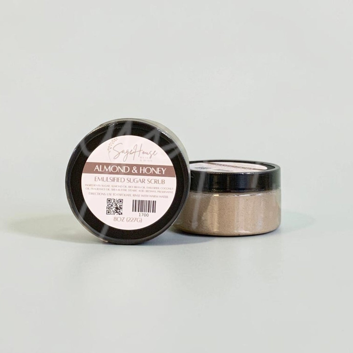 Two jars with black lids and white labels. On a white background.