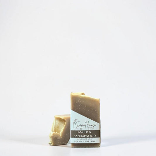 A labeled bar of soap sitting in front of a matching bar of soap. On a white background.