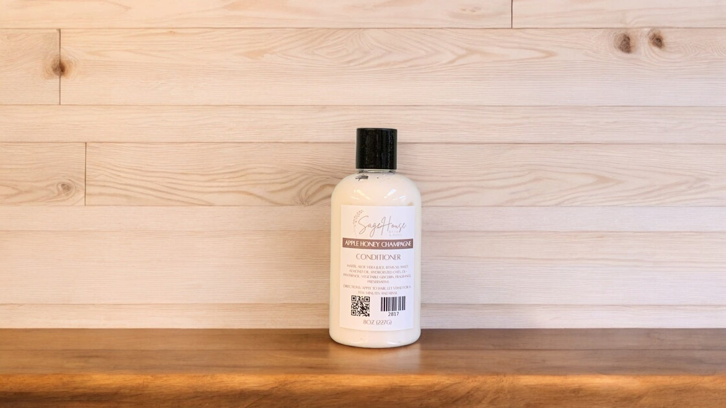 A bottle of conditioner with a black cap. Sitting on a wood surface with a light wood background
