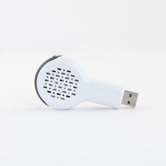 A white Aroma Breeze car diffuser with a USB port, designed to plug into a vehicle for aroma distribution.