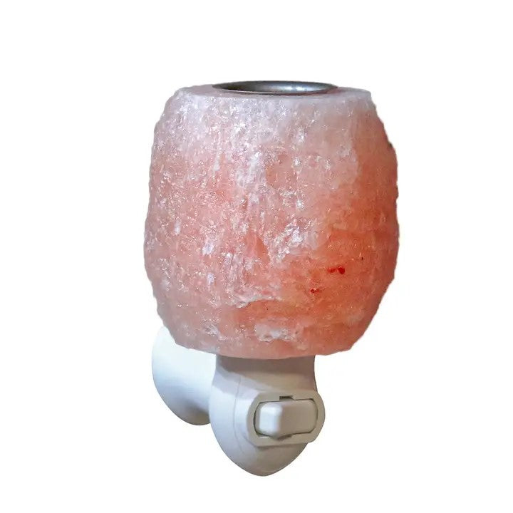 A night light salt lamp with cup on top for adding essential oils. On plug in switch base