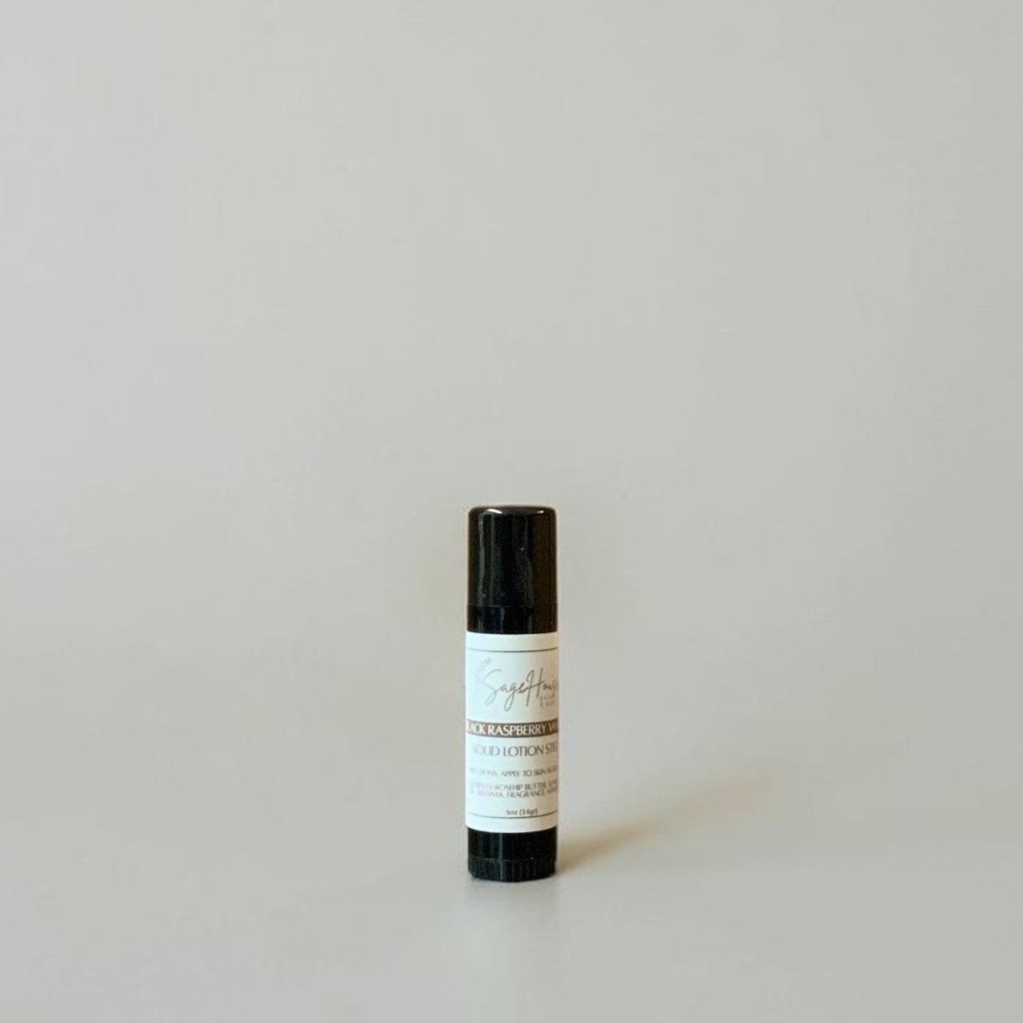 A black tube with label on a light gray background