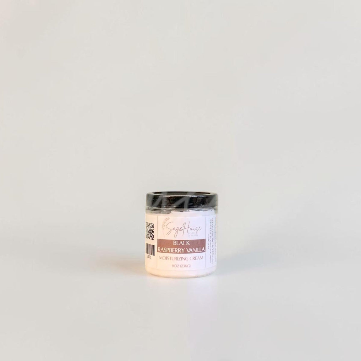 A labeled jar with a black lid. On a neutral background.
