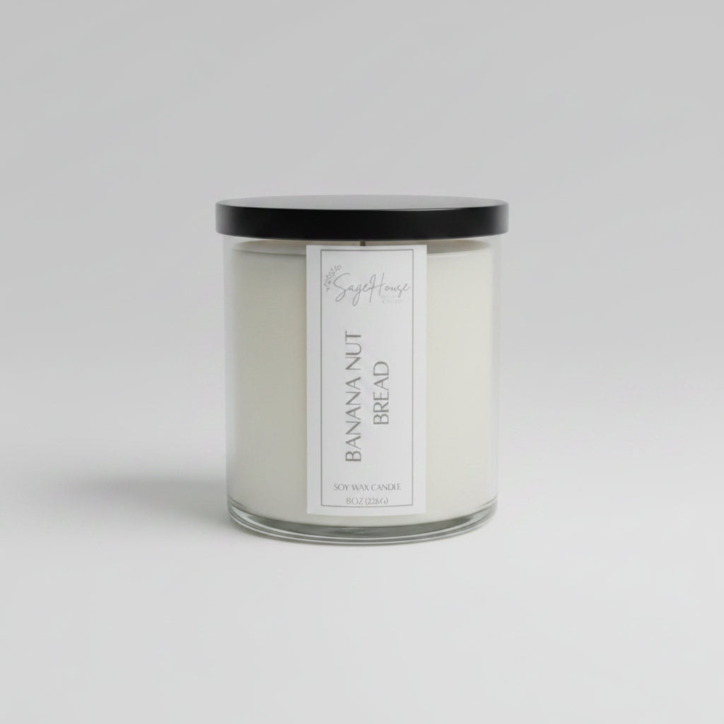 A white soy wax candle in a clear container, placed on a wooden surface, with a label on the front.