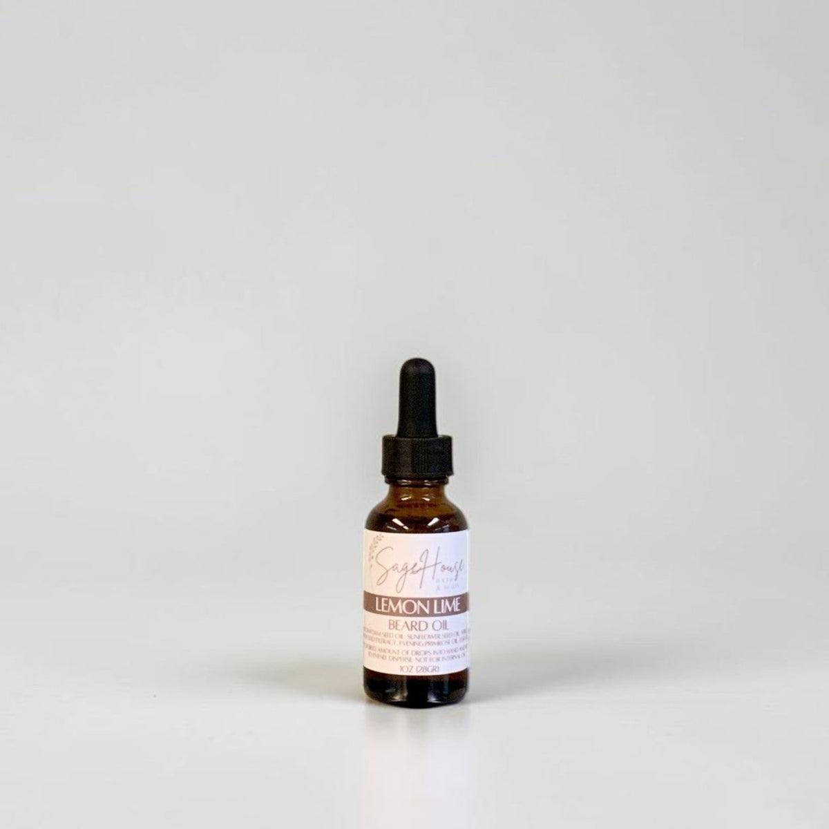 A small amber glass dropper bottle with a black dropper cap and a white label, centered against a plain light gray background.