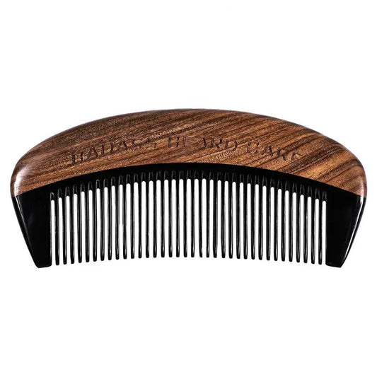A hand-carved wooden beard comb with sandalwood spine and ox horn teeth.