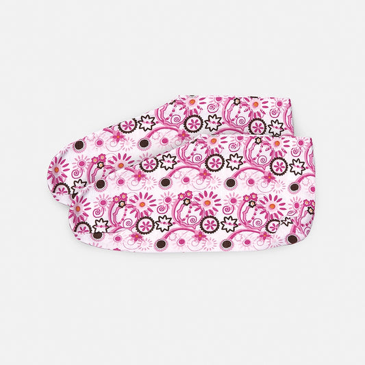A pair of pink moisturizing socks with a floral pattern and a branded tag on the side.