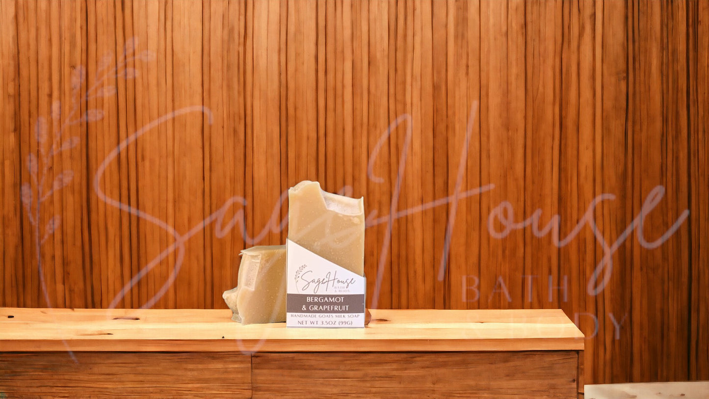 A tan bar of soap in a white labeled box, on a wood surface.
