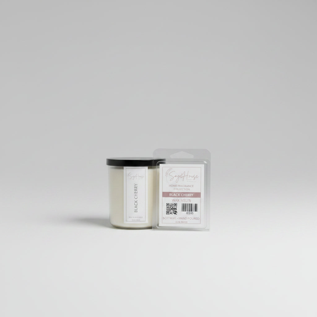 A white soy wax candle in a clear container, next to a clear clamshell wax melt package, placed on a wooden surface, with a label on the front.