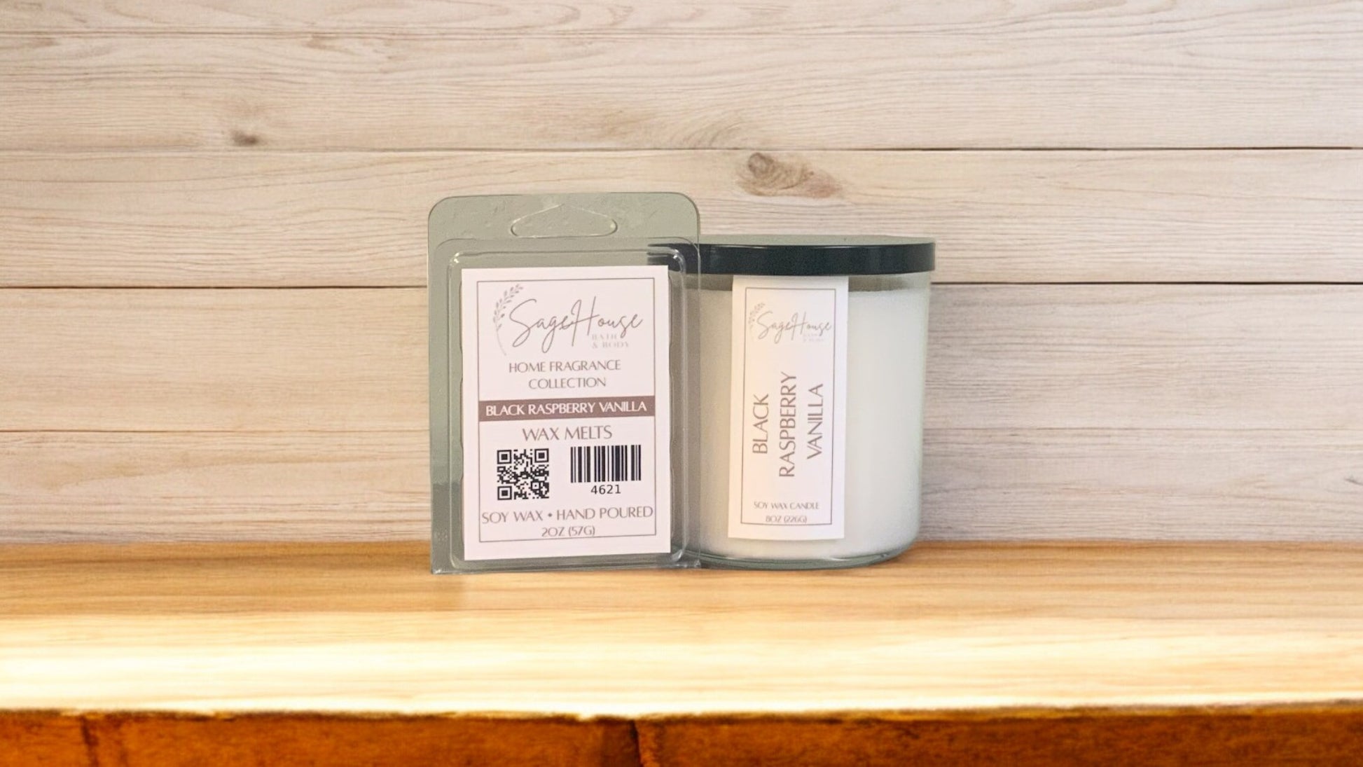 A white soy wax candle in a clear container, next to a clear clamshell wax melt package. placed on a wooden surface, with a label on the front.