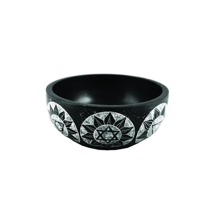 A Soapstone Bowl black color, with various sun designs on a white background