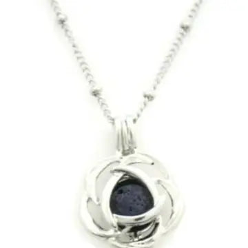 A silver flower shaped necklace with lava bead inside. on a silver chain