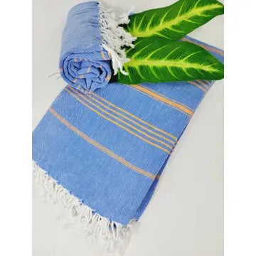 Blue Turkish cotton towel, folded onto itself, on a gray background with 2 leaves.