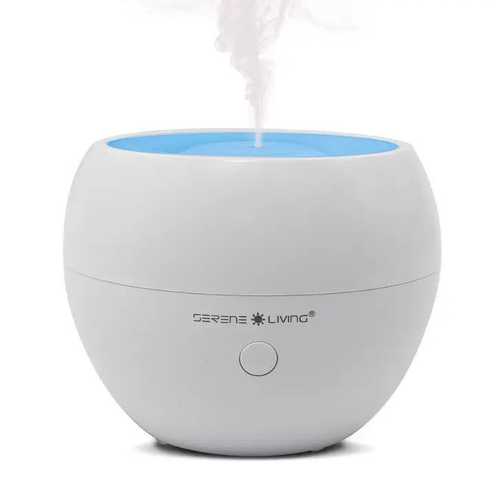 A white and blue oil diffuser with a visible mist coming out from the top.