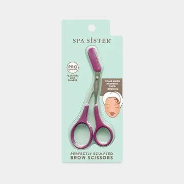 A pair of Spa Sister brow scissors with purple handles and a detachable styling comb, packaged on a card with the product information.