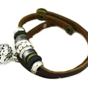 bracelet with brown leather and silver and black beaded accents, with lava bead inside of silver ball attached.