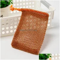 A Soap Scrub Pouch in brown, placed on a white surface. A basket and plant in the background.