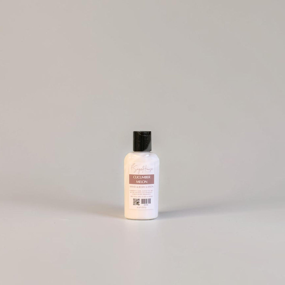 A small bottle of lotion with black cap and white label. On a white background.