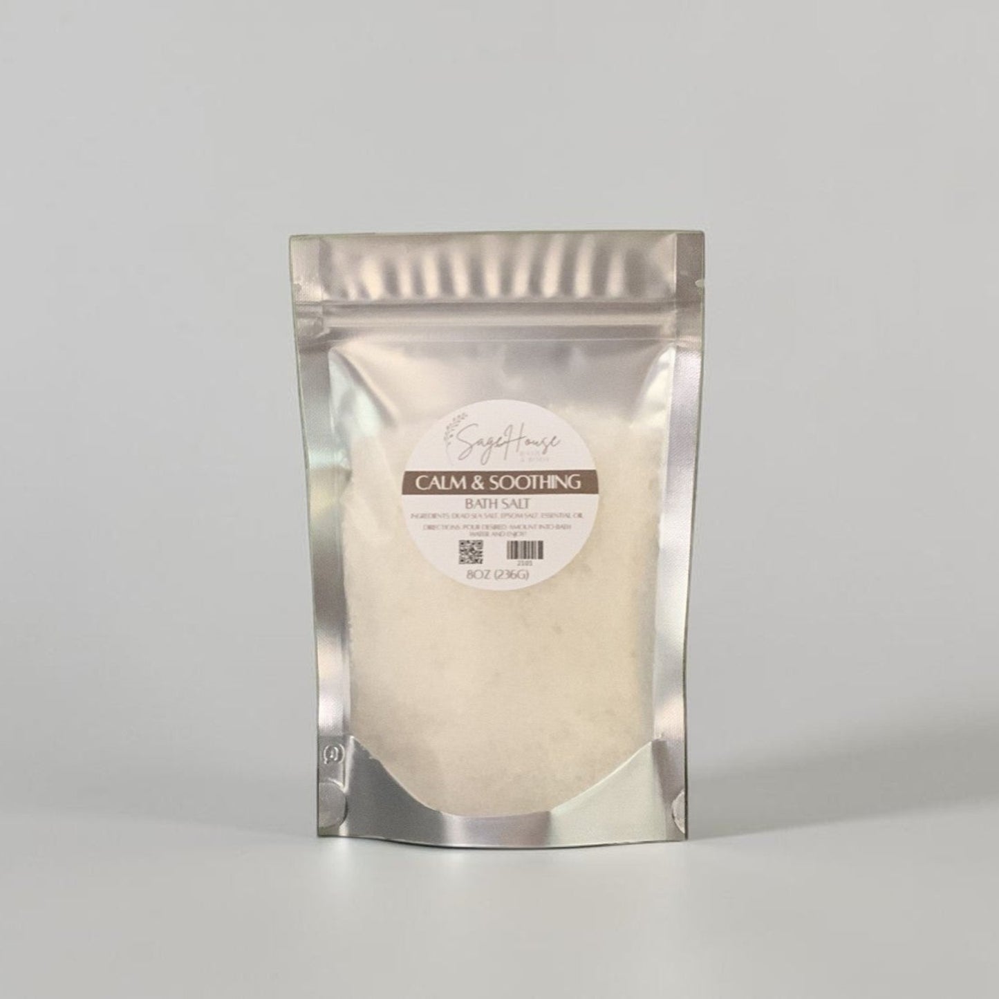Silver packaging with a label on a grey background.