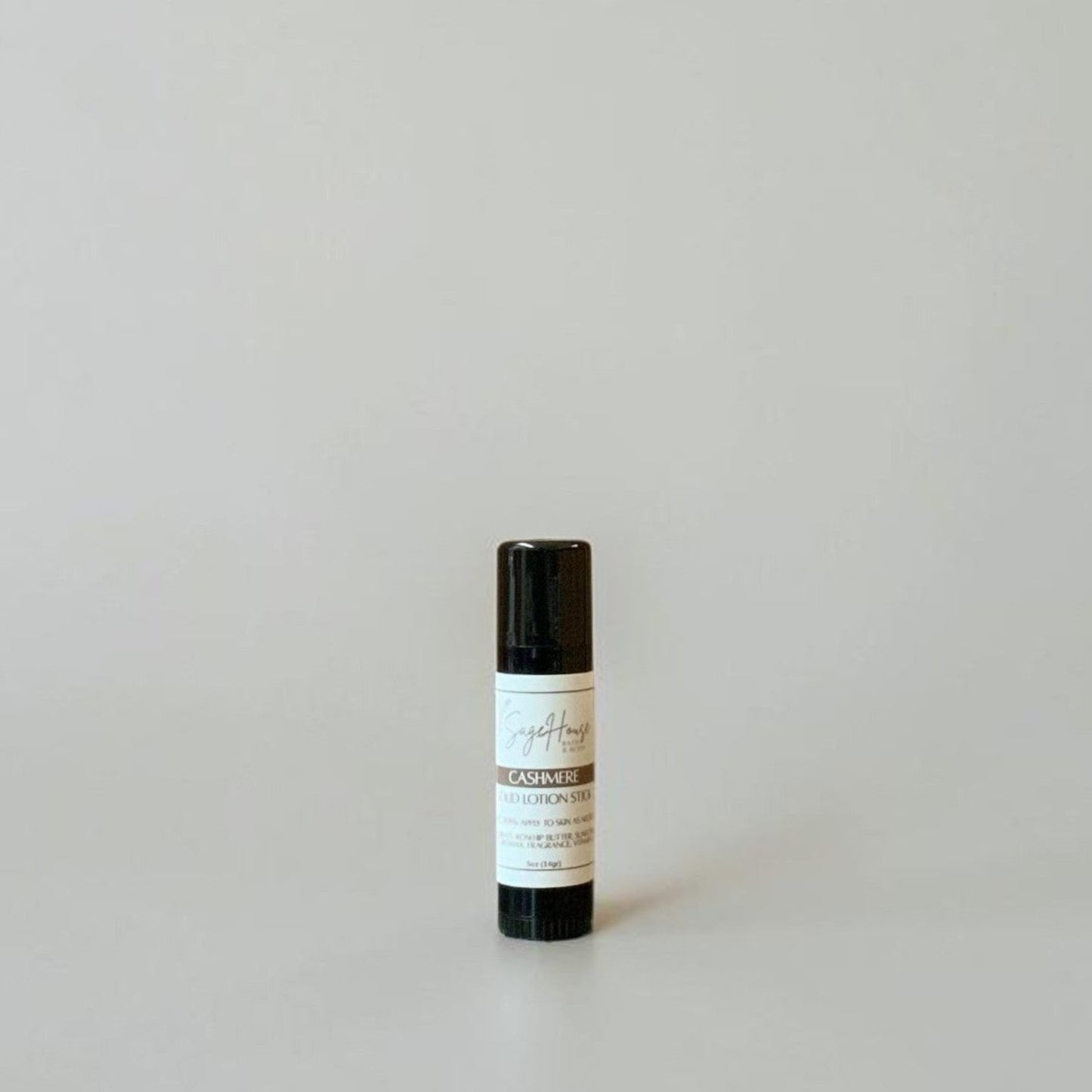 A black tube with label on a light gray background