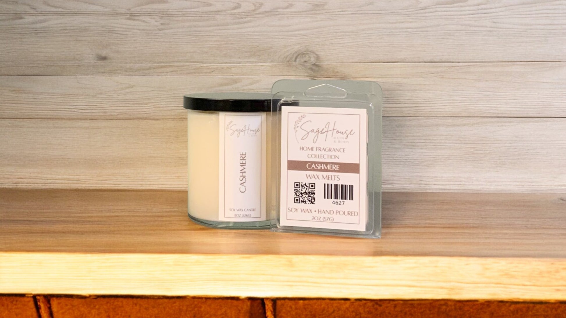 A white soy wax candle in a clear container, next to a clear clamshell wax melt package. placed on a wooden surface, with a label on the front.