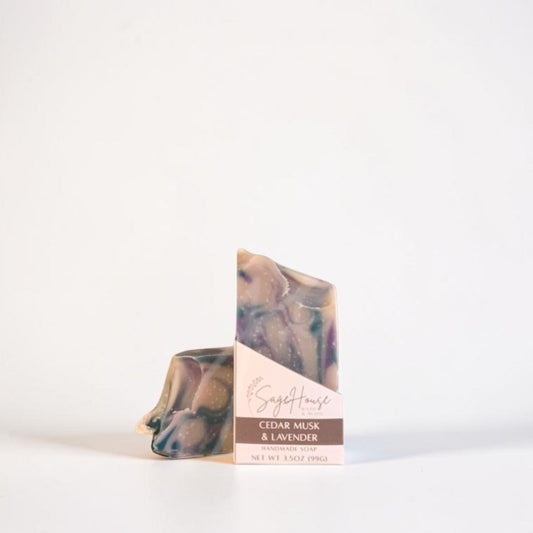 2 bars of soap, the front with a labeled sleeve. located on a white background.