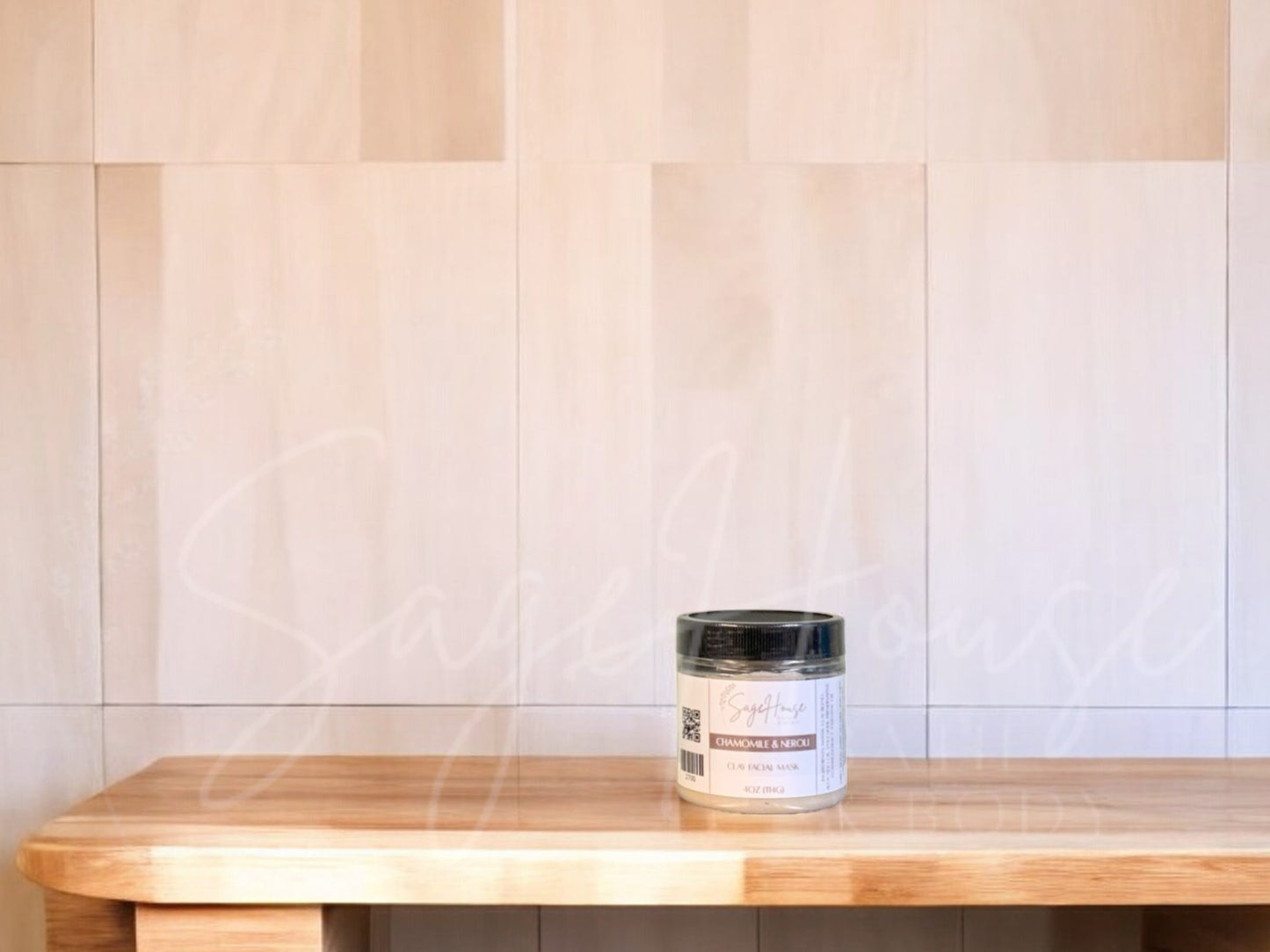 A face mask product in a small container, with a beige background resembling a wooden texture.