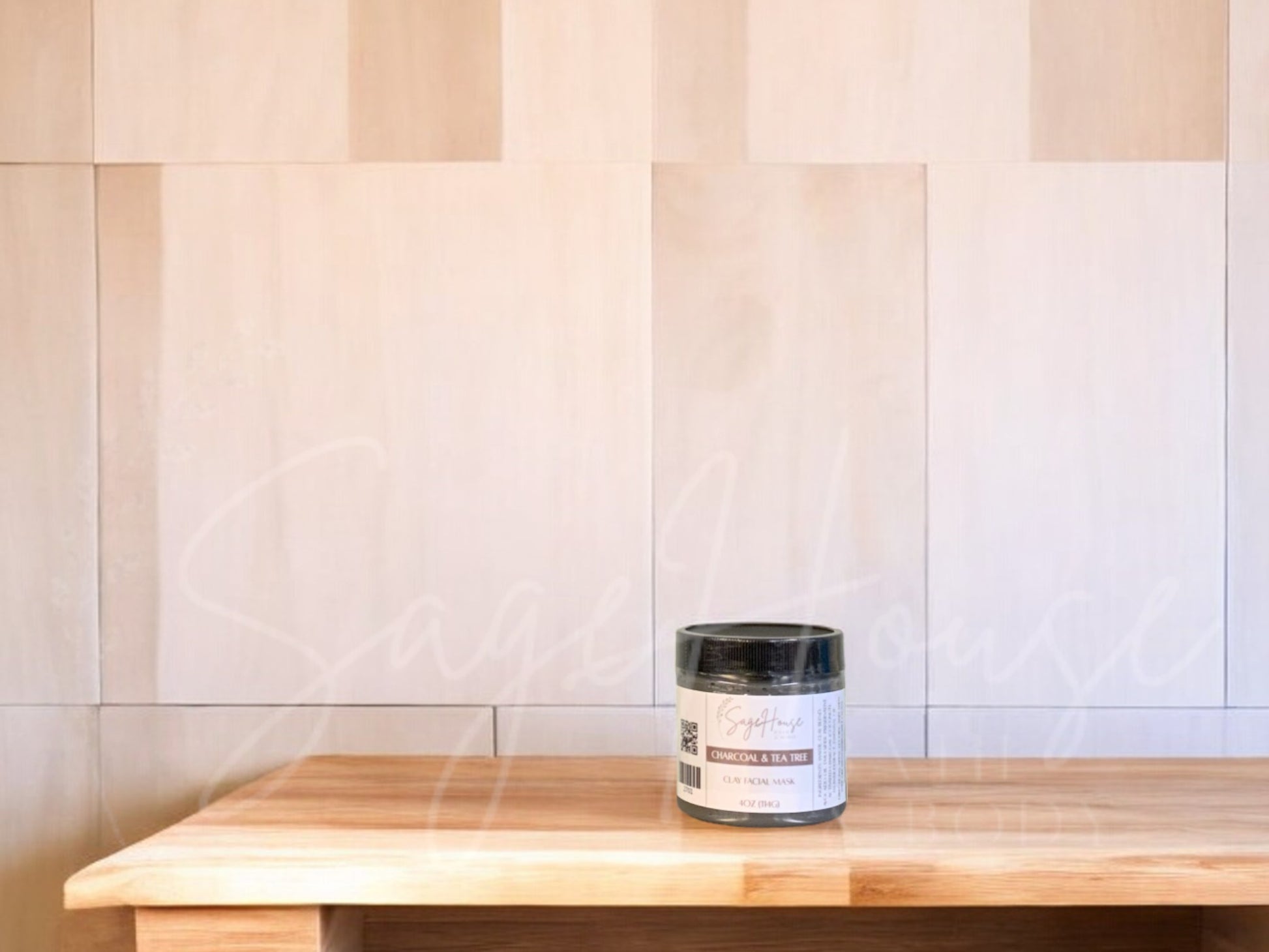 A face mask product in a small container, with a beige background resembling a wooden texture.