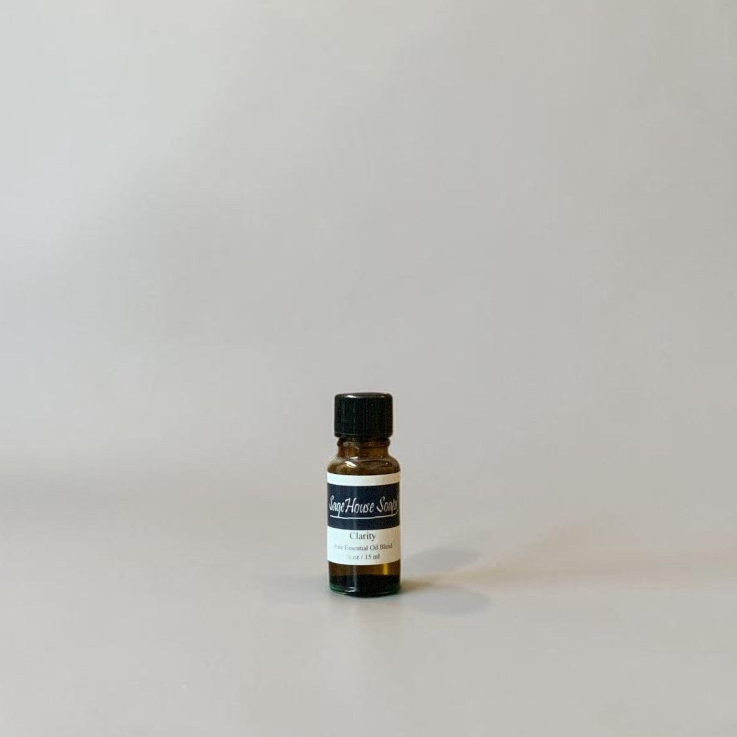Bottle of Essential oil on a grey background.