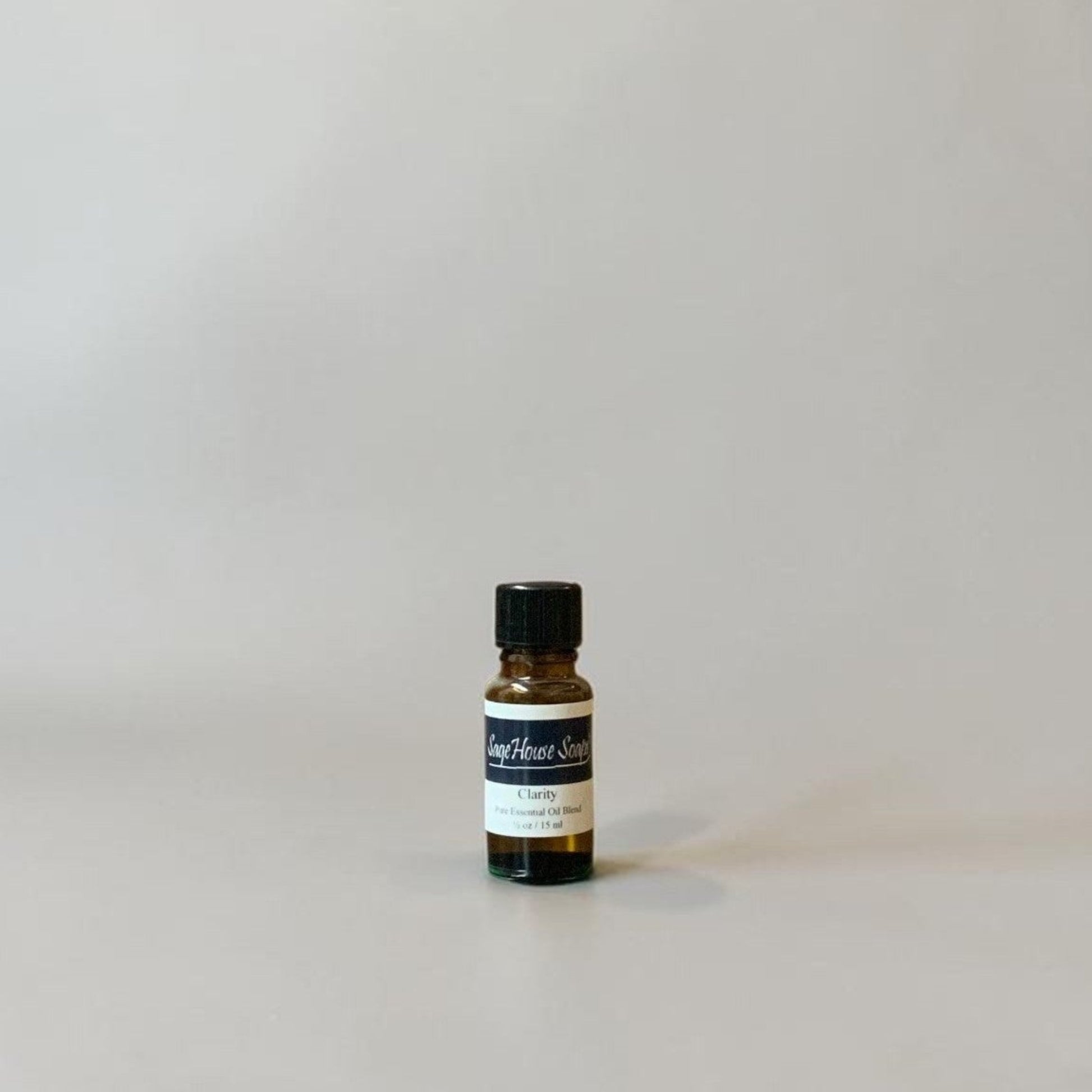 Bottle of Essential oil on a grey background.
