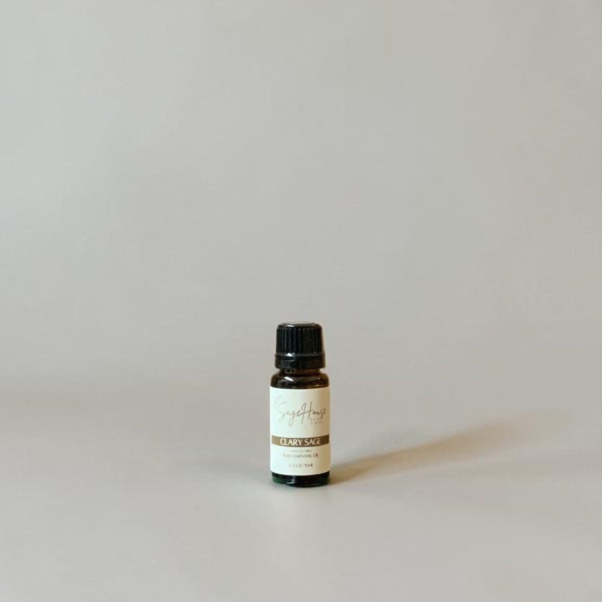 Bottle of Essential oil on a grey background.